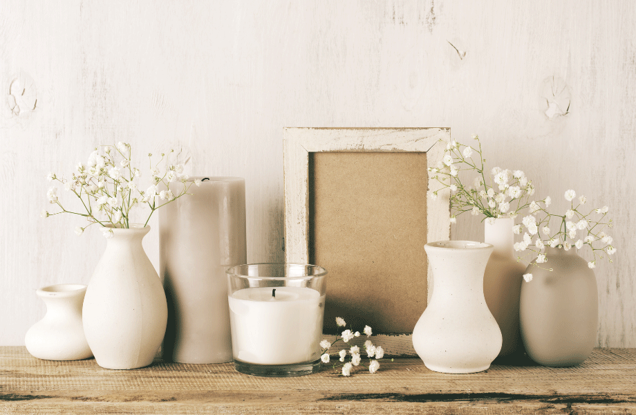 image of white and taupe vases and knick knacks arranged on a taupe board for garden colour scheme