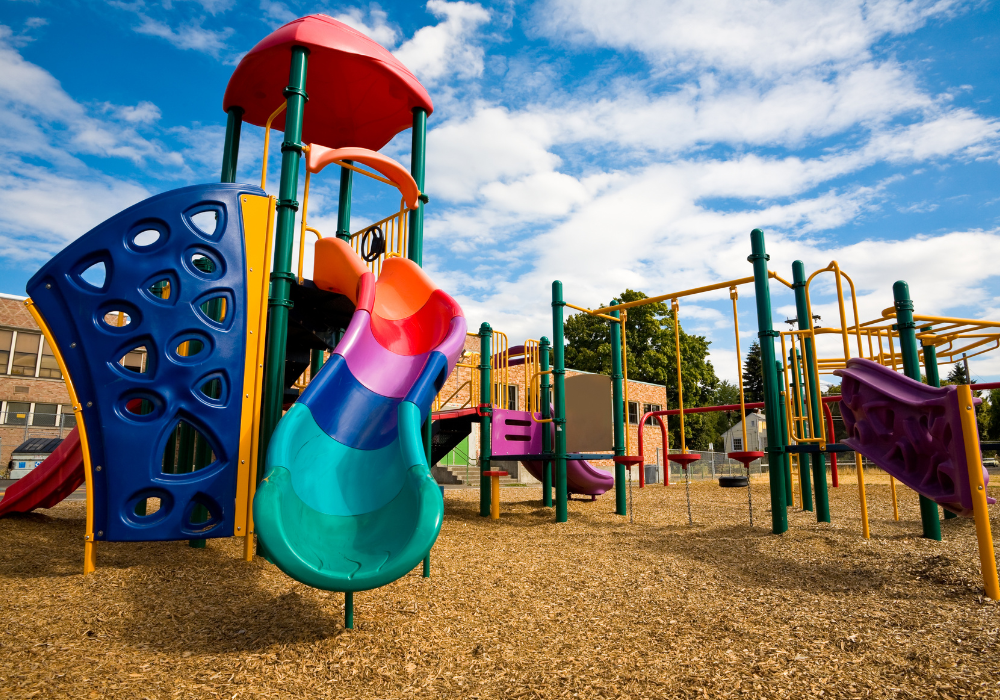 brightly coloured playground with mulch