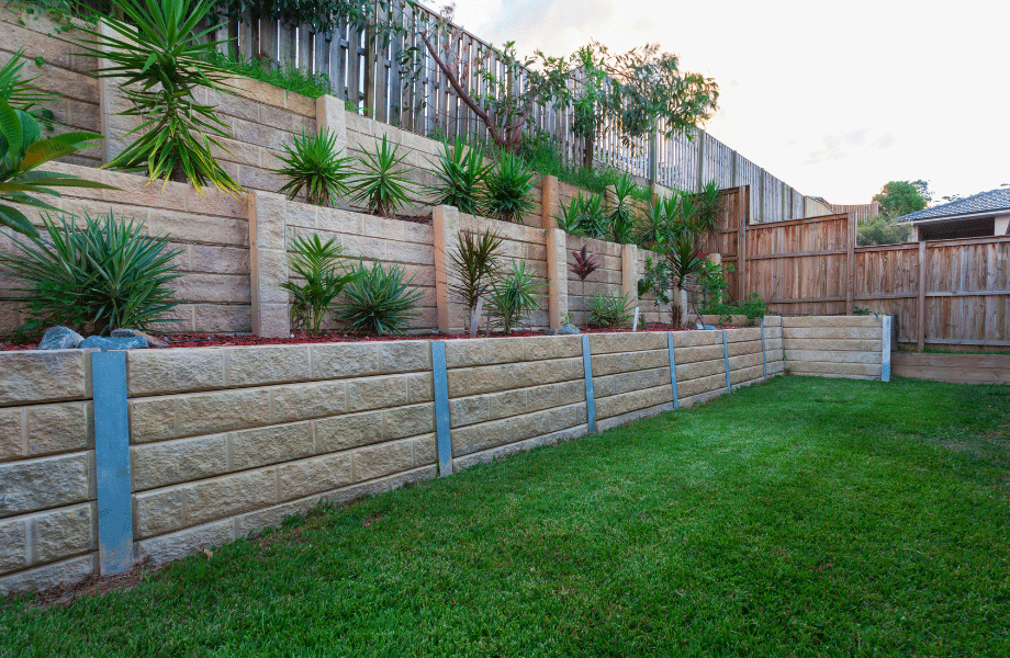 image of a multi level garden bed with a green lawn and plantings on the tiers