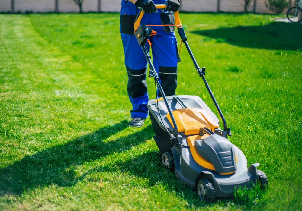man in blue suit mowing