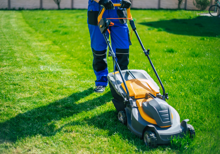 man in blue suit mowing