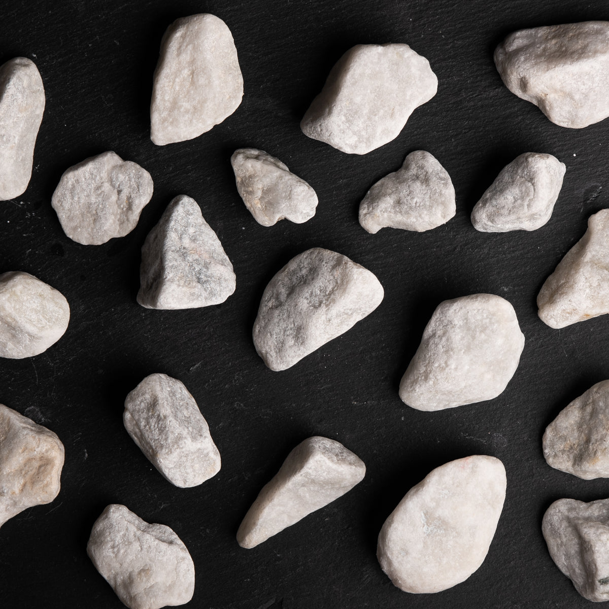 Pattern of light gray stones on a black background