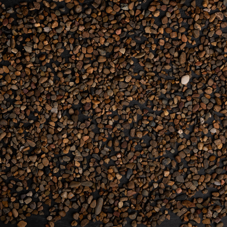 Close-up of small brown stones on a black background