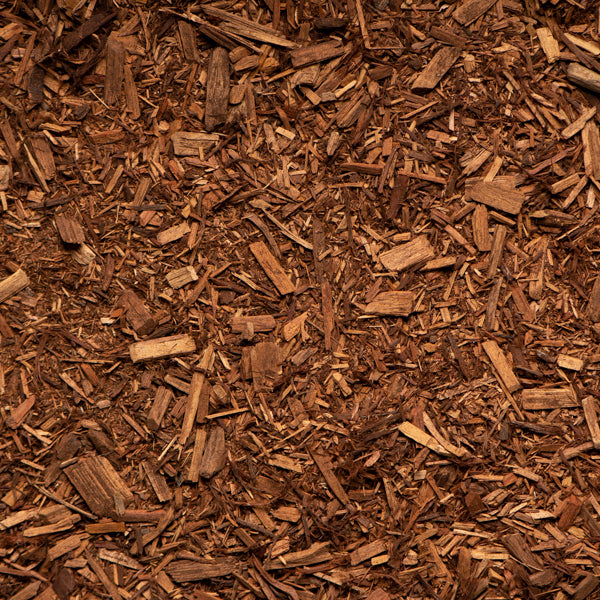 Close-up of wood chips or mulch with a brown color.