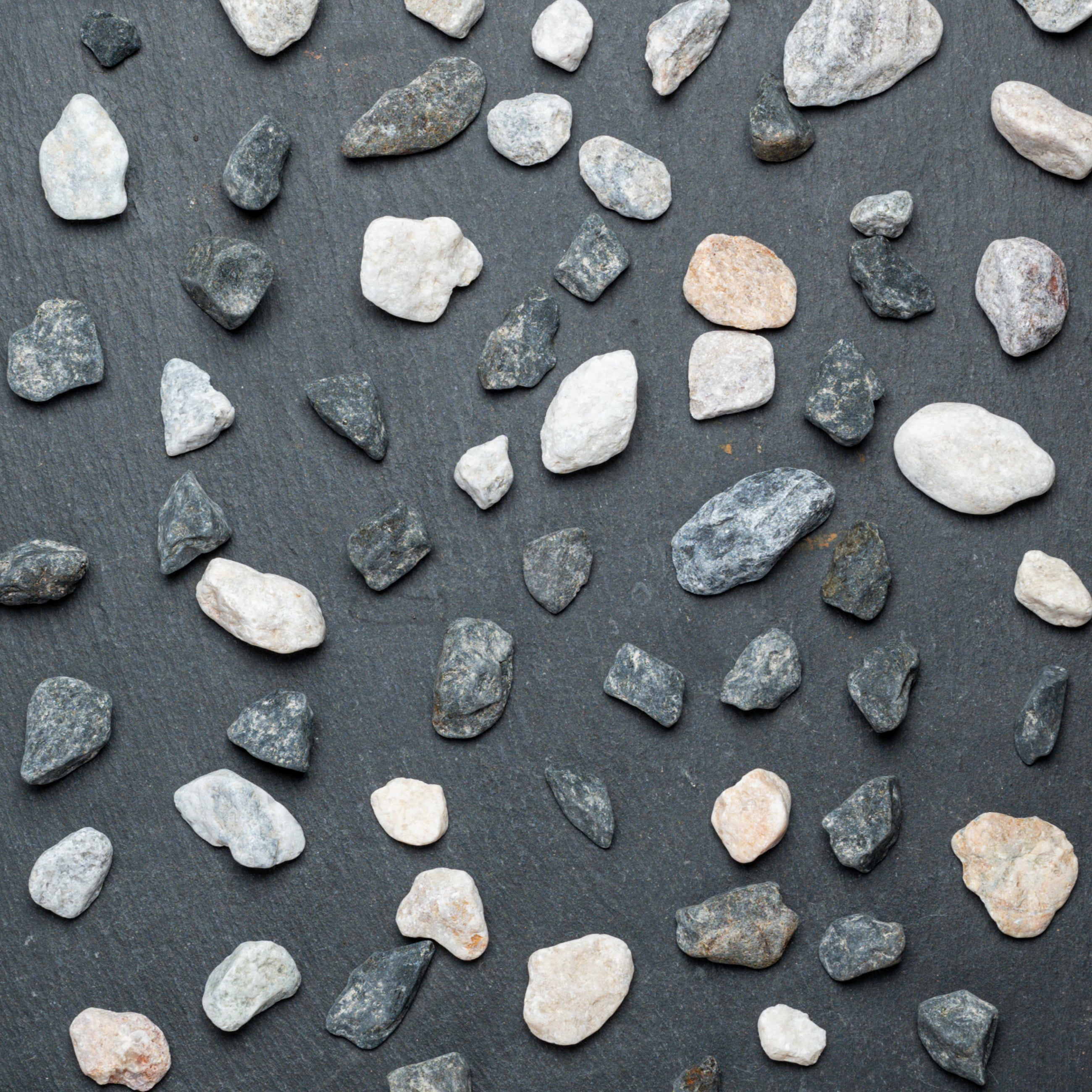 Pattern of small stones on a dark surface
