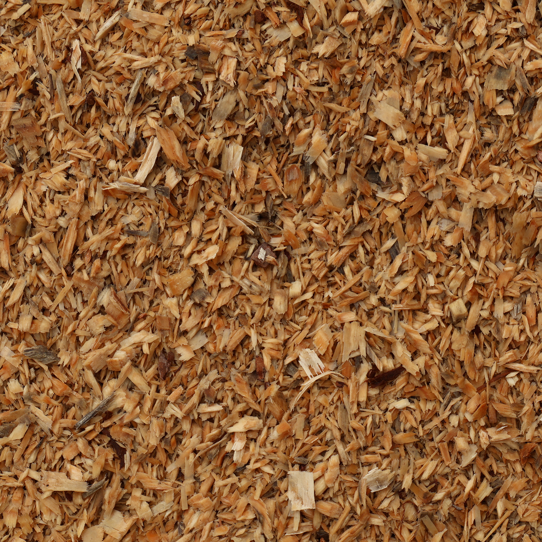 Close-up of wood chips or mulch with a brown color.