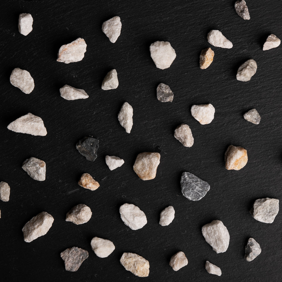 Small stones scattered on a black surface