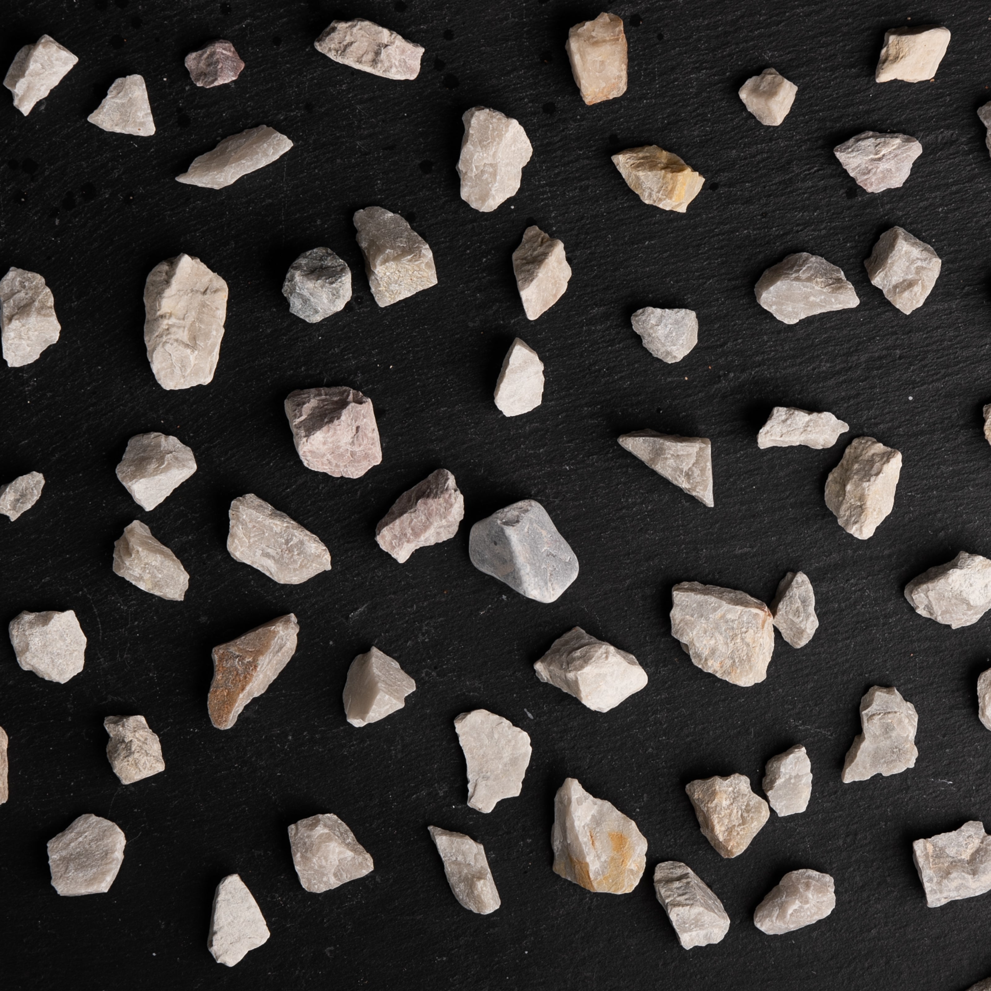Small stones scattered on a black background
