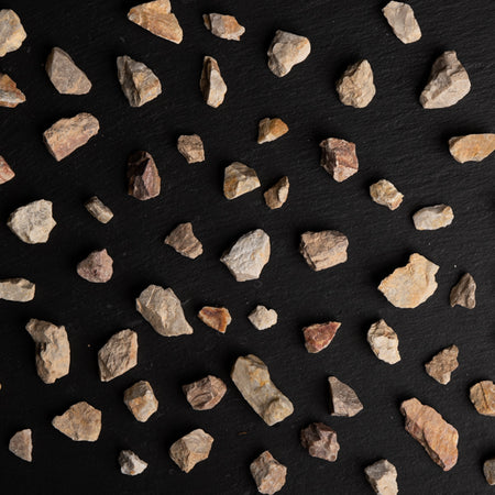 Small rocks scattered on a black surface