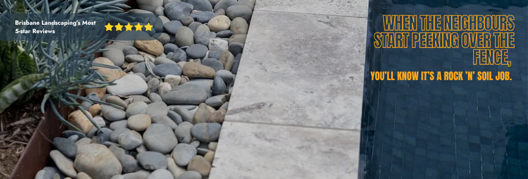 Paved area with rocks and a humorous quote about neighbors peeking over a fence.