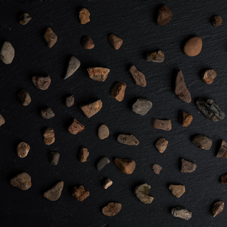 Small rocks scattered on a dark surface