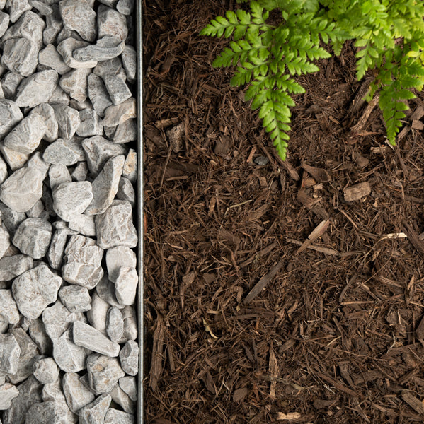 Three sections of gravel, soil with mulch, and green fern leaves.