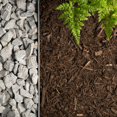 Three sections of gravel, soil with mulch, and green fern leaves.