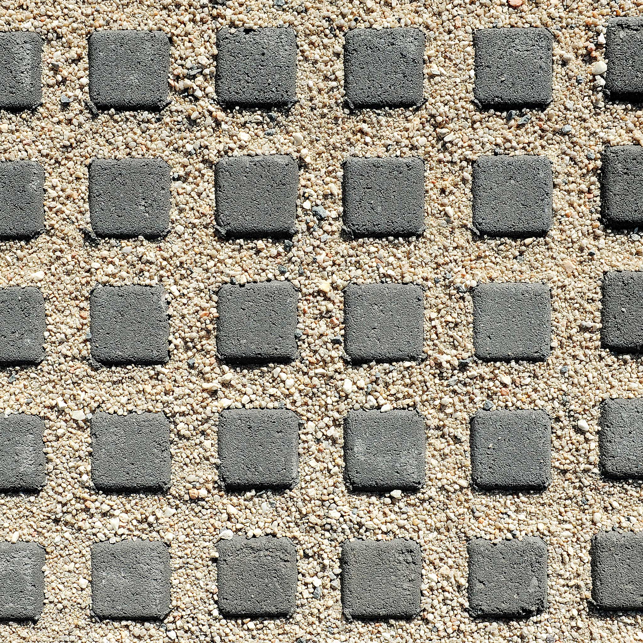 Pattern of gray square stones on a sandy surface