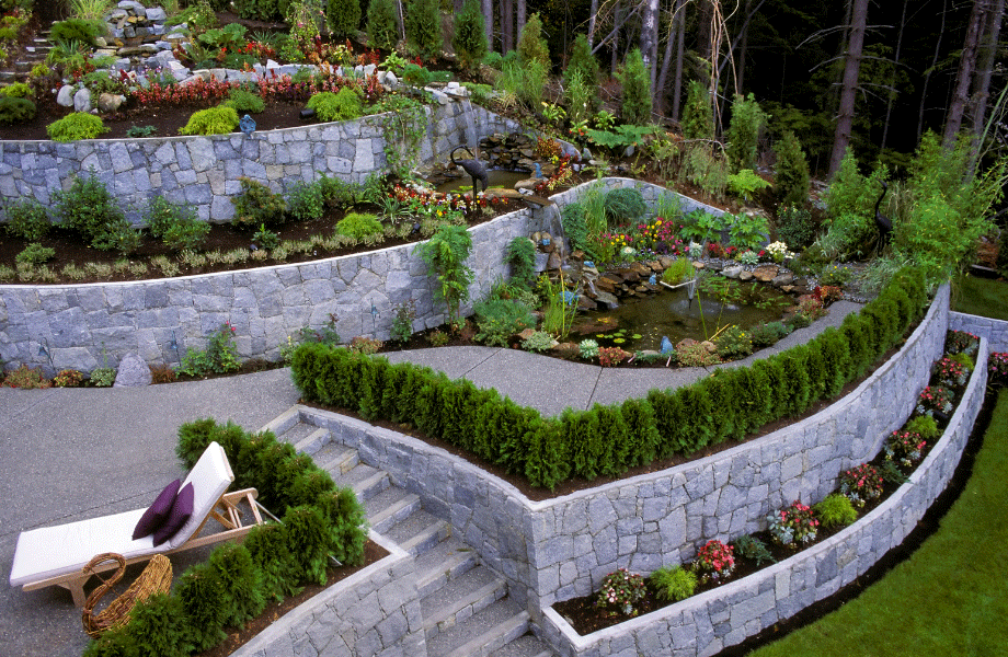 image of a modern stone multi level garden bed with fresh and clean plantings and a sun lounger