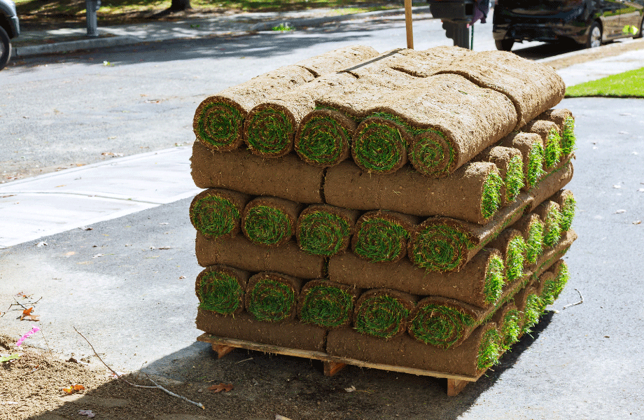 pallet of rolled and stacked nullarbor couch grass sitting on driveway in a neighbourhood